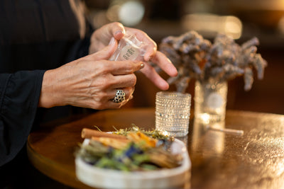 Assembled ritual candle with warm glow — sets intention for the self-care experience
