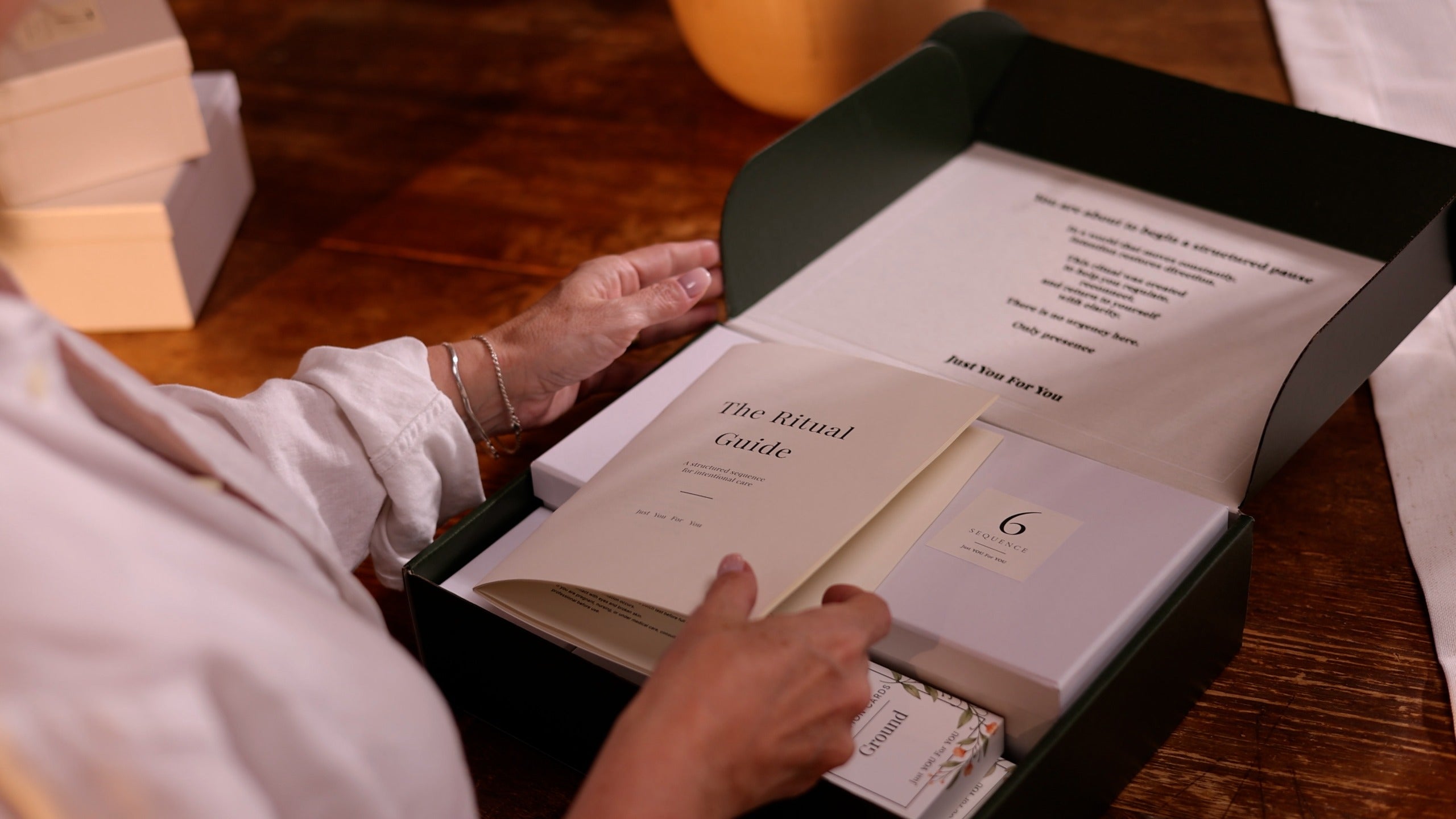 Hands opening a Just You For You box with The Ritual Guide